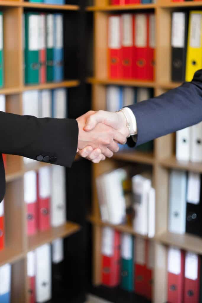 two businessmen shaking hands on a merger