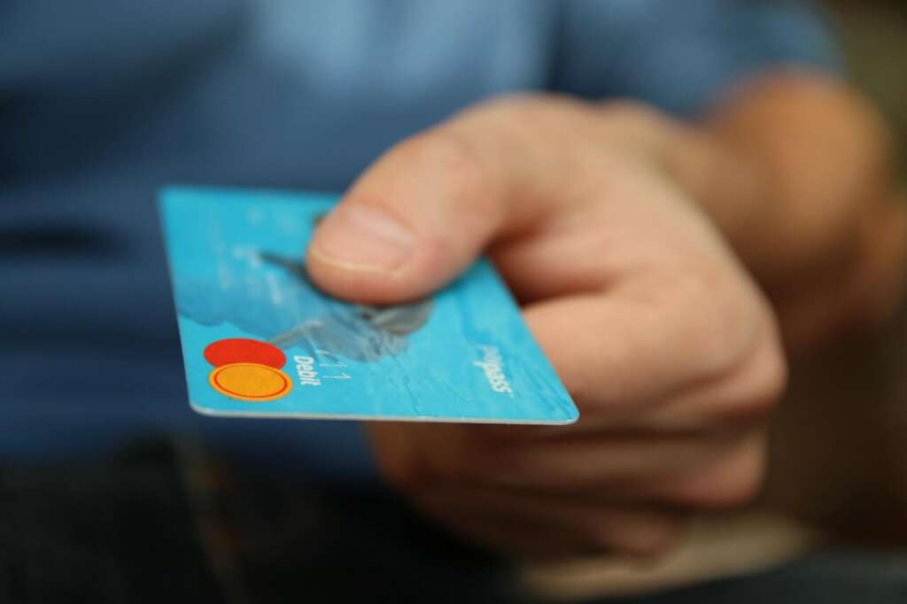 Person holding debit card